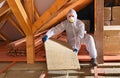 Man with rockwool panel installing insulation layer