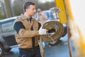 Man with rolled hose reel