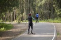 A man on a roller ski rides in the park.Cross country skilling Royalty Free Stock Photo