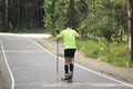 A man on a roller ski rides in the park.Cross country skilling Royalty Free Stock Photo