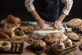 Man rolling out dough on kitchen table, close up Royalty Free Stock Photo