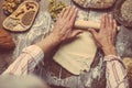 Man rolling out dough on kitchen table, close up Royalty Free Stock Photo