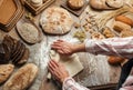 Man rolling out dough on kitchen table, close up Royalty Free Stock Photo