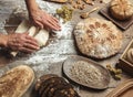 Man rolling out dough on kitchen table, close up Royalty Free Stock Photo