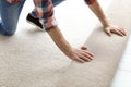 Man rolling out new carpet flooring Royalty Free Stock Photo