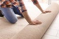 Man rolling out new carpet flooring Royalty Free Stock Photo