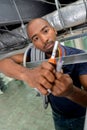 Man in roof space holding cables and tester Royalty Free Stock Photo