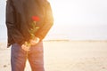 Man with a rose behind his back waiting for love. Romantic date Royalty Free Stock Photo