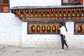 Man rotating the prayer mills in a buddhist tempel