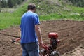 Man rototilling garden. Royalty Free Stock Photo