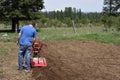 Man rototilling garden. Royalty Free Stock Photo