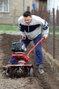 Man rototilling garden. Royalty Free Stock Photo