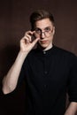 Man in round glasses and a black shirt