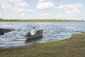 Man in a rowboat on the bank of the Rio Negro, in Mercedes, Uruguay