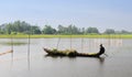 A man rowing boat on the field at flood season in Tra Vinh province, Vietnam Royalty Free Stock Photo