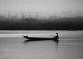 A man rowing boat in a misty lake