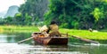 Man in rowing boat by Nin Binh in Vietnam