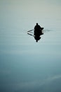 Man in a rowing boat oars in the water Royalty Free Stock Photo