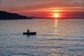 Man rowing a boat during sunset Royalty Free Stock Photo