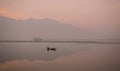 Man rowing his boat on a Peaceful Sunrise Royalty Free Stock Photo