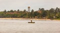 Man rowing an outrigger boat offshore