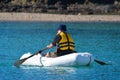 Man rows dinghy boat Royalty Free Stock Photo