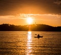 A man rows on a lake at sunrise Royalty Free Stock Photo