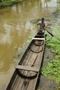 A man rows a traditional boat