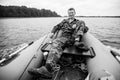 A man on rubber boat on the lake. Black and white photo. Royalty Free Stock Photo