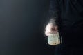 Man in rubber glove sprays disinfectant on a glass, selective focus