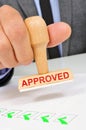 Man with a rubber stamp with the word approved Royalty Free Stock Photo