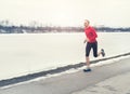 Man runing near winter lake