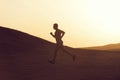 Man runner running in dune at sunset Royalty Free Stock Photo