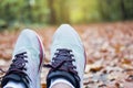 Man runner foot in the fall leaves on the ground in the forest in autumn season