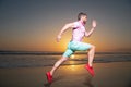 Man runner jogger running. Young guy running along the beach of the sea during an amazing sunset. Royalty Free Stock Photo