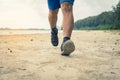 Man runner legs running closeup on shoe, Men jogging on the beach