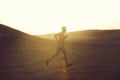 Man runner running in dune at sunset Royalty Free Stock Photo
