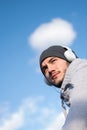 Man runner taking a break after intensive training outdoors, listening music on his mobile smart phone Royalty Free Stock Photo