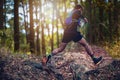 A man Runner of Trail . and athlete`s feet wearing sports shoes for trail running in the forest