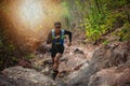 A man Runner of Trail . and athlete`s feet wearing sports shoes for trail running in the forest Royalty Free Stock Photo