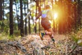 A man Runner of Trail and athlete`s feet wearing sports shoes for trail running in the forest Royalty Free Stock Photo