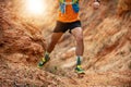 A man Runner of Trail . and athlete`s feet wearing sports shoes for trail running in the forest Royalty Free Stock Photo