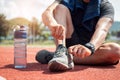 Man runner tying shoelaces on track stadium Royalty Free Stock Photo