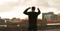 Man, runner or victory in city for exercise time, fitness progress or training goal. Male person, athlete or cheers or