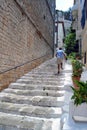 A man runnig up the stairs in old town of Nafplio