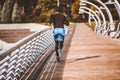 Man running along  modern bridge. Exercising, Jogging, Sport. Male athlete running Royalty Free Stock Photo