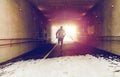 Man running along subway tunnel in winter