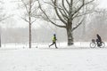 A man running in the Amsterdam Vondelpark on a snowy winter day