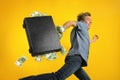 Man running away with a briefcase overstuffed with cash Royalty Free Stock Photo