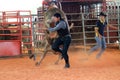 Man running from bull at the rodeo